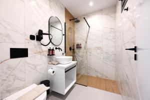 a bathroom with a sink and a shower at kallos of Skiathos in Skiathos +47 photos