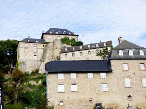 a large building with a castle in the background at Relaxen am Nationalpark Eifel in Ahrhütte