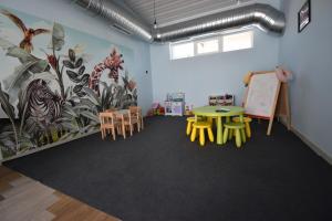 a classroom with a table and chairs and a chalkboard at Simada Center Guesthouse in Varshets