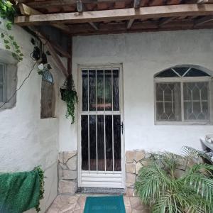 a front door of a white house at Casa Singela in Miguel Pereira