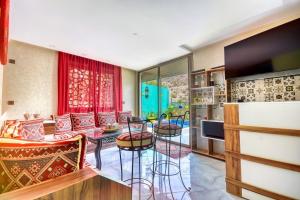 a kitchen and living room with a table and chairs at HoneyPath Atlas Retreat in Agadir