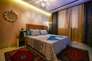 a bedroom with a bed and a mirror on the wall at HoneyPath Atlas Retreat in Agadir