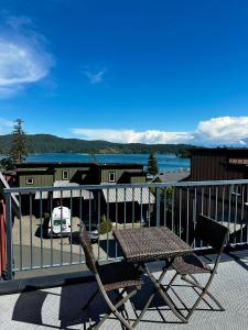 a pair of chairs and a table on a balcony at Sooke Harbour Townhouse - Waterfront 2-Bed Rental in Sooke
