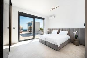 a bedroom with a bed and a view of the ocean at Krimovica Villas in Budva