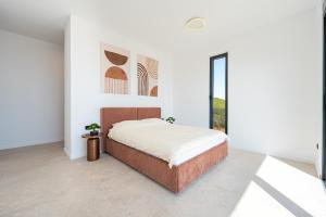 a white bedroom with a bed and a window at Krimovica Villas in Budva +73 photos