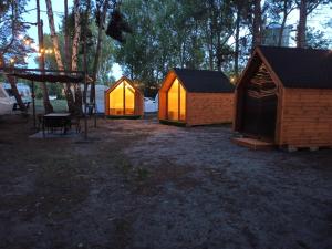 a group of three small tents in a field at Happy House Hel in Hel +10 photos