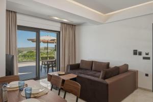 a living room with a couch and a table at Aurelia Luxury House in Amoudara Herakliou