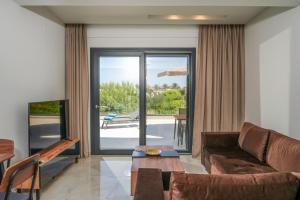 a living room with a couch and a table at Aurelia Luxury House in Amoudara Herakliou