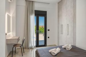 a bedroom with a bed and a desk and a window at Aurelia Luxury House in Amoudara Herakliou +36 photos