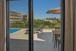 a view of a patio with a table and a pool at Aurelia Luxury House in Amoudara Herakliou