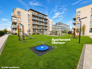 a playground in front of a building with a slide at Apartament Glamour - 5 Mórz - Basen - SPA - Sauna in Sianozety