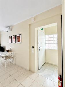an open door in a room with a table at Agapidis Apartment in Hanioti