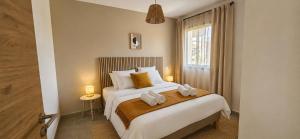 a bedroom with a bed with two towels on it at Résidence Saint Flor in Saint-Florent +36 photos