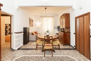 a kitchen and dining room with a table and chairs at "Cà Niella" in centro e a 9 m dal mare in Savona