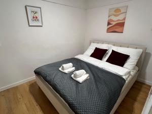 a bedroom with a bed with two towels on it at Apartament przy Agorze in Bytom