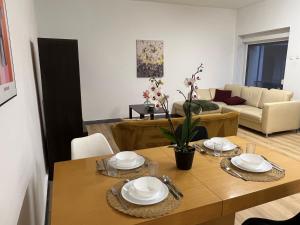a living room with a table and a couch at Apartament przy Agorze in Bytom
