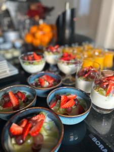 a table topped with bowls of fruit and desserts at B&B Prachtig Allemachtig in Valkenburg +31 photos