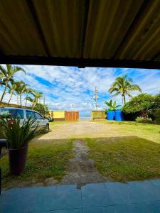 a car parked in a yard with palm trees at Pousada Cantinho do Mar - pé na areia in Guarujá