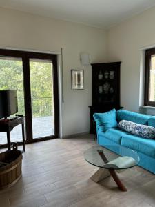 a living room with a blue couch and a table at Villa Nina in Caporciano