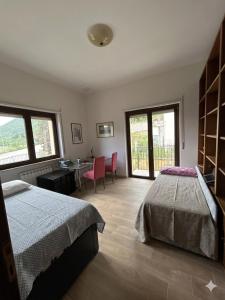 a bedroom with a bed and a table and chairs at Villa Nina in Caporciano