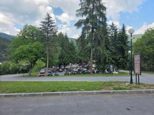 a street with a parking lot and a sign on the road at Konak Studenica 1186 in Kraljevo