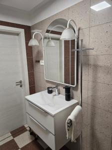 a bathroom with a white sink and a mirror at Mandala Terra in Gračišče +12 photos