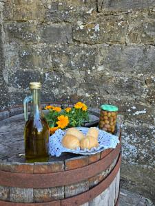 a barrel with bread and a bottle of wine and flowers at Mandala Terra in Gračišče