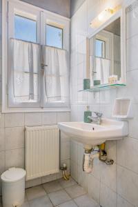 a bathroom with a sink and a toilet at Aiolos Rooms in Tsoukalades