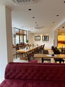 a dining room with wooden tables and chairs at Konak Studenica 1186 in Kraljevo