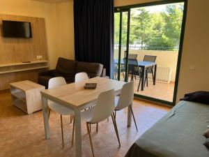 a living room with a table and chairs and a couch at Cap Salou Binda Mar Apartment in Salou