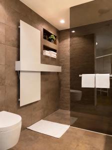 a bathroom with a toilet and a sink at The Crown Penthouse Bahnhofstrasse in Zurich
