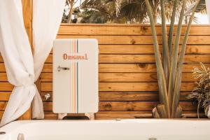 a white refrigerator with the word original written on it at The Beach House Estadias in Itapoa