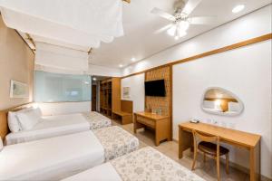 a hotel room with two beds and a desk at Blue Tree Thermas de Lins Resort in Lins +98 photos