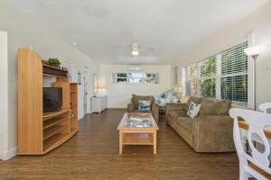 a living room with a couch and a table at Bahama Beach Club Pompano - Fort Lauderdale - Charming and Cozy Studios & Apartments close to Beach with heated Pool in Pompano Beach