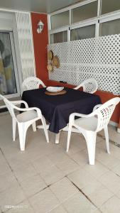 a table and chairs sitting on a patio with a table and chairs at Apartamento Perea playa in Tavernes de Valldigna