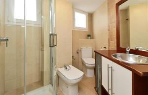a bathroom with a sink, toilet and shower at Apartamentos Calle Larios in Málaga