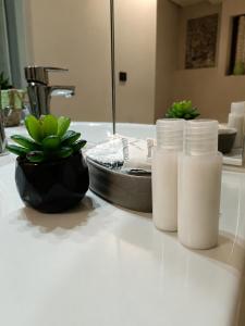 two bottles of milk sitting on a counter in a bathroom at La Tavernetta in Casto