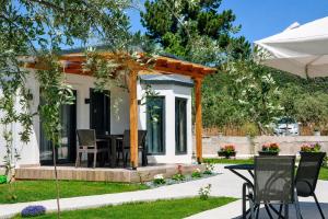 a house with a table and chairs in a yard at Aivazidis Residence II in Skala Kallirachis