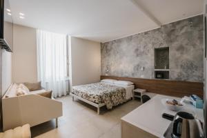 a hotel room with a bed and a table at Marinucci Rooms in Termoli