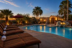 a swimming pool with lounge chairs in a resort at La Posada Lodge & Casitas, an Ascend Collection Hotel in Tucson