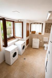 a bathroom with two washing machines and a toilet at La Tavernetta in Casto
