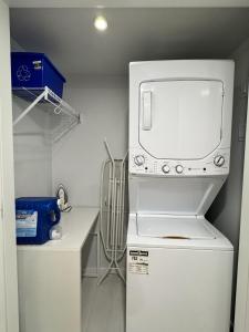 a washer and dryer in a small kitchen at Cozy South Surrey Private Suite 1 Bedroom - 2 Beds - Separate Entrance in Surrey