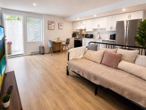 a living room with a couch and a kitchen at Cozy South Surrey Private Suite 1 Bedroom - 2 Beds - Separate Entrance in Surrey