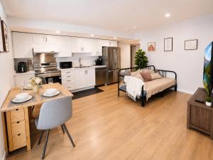 a kitchen and living room with a table and a couch at Cozy South Surrey Private Suite 1 Bedroom - 2 Beds - Separate Entrance in Surrey