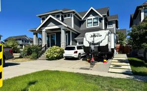 a white truck parked in front of a house at Cozy South Surrey Private Suite 1 Bedroom - 2 Beds - Separate Entrance in Surrey