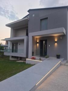 a gray house with lights on the side of it at Minimal Nature Escape in Ioannina