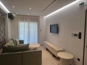 a living room with a couch and a table at Minimal Nature Escape in Ioannina