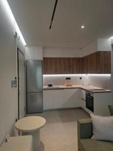 a kitchen with a couch and a table and a refrigerator at Minimal Nature Escape in Ioannina