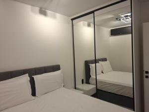 a mirror in a room with a bed and a bed sqor at Minimal Nature Escape in Ioannina