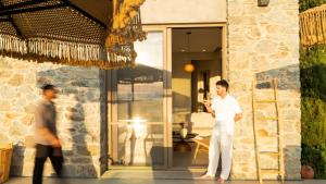 a man is standing outside of a house at Theros Villas Naxos in Plaka +209 photos